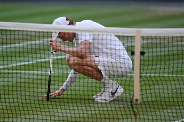 Italy's Jannik Sinner celebrates after beating Carlos Alcaraz of Spain to win the men's singles final at the Wimbledon Tennis Championships in London, Sunday, July 13, 2025. (AP Photo/Kin Cheung)