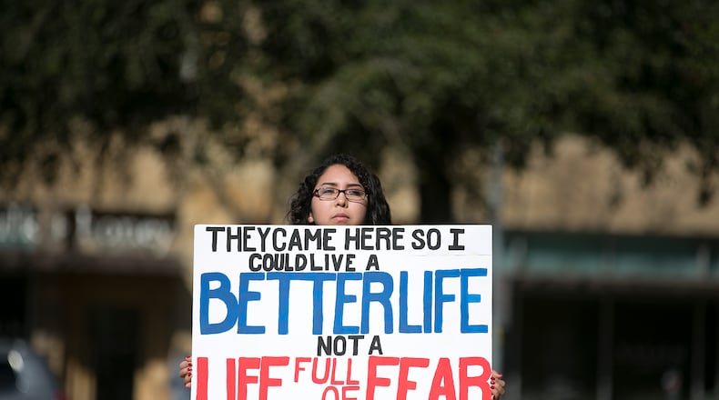 A protester holds a sign at a recent rally in Texas in conjunction with the increased federal and state focus on undocumented students. DEBORAH CANNON / AMERICAN-STATESMAN