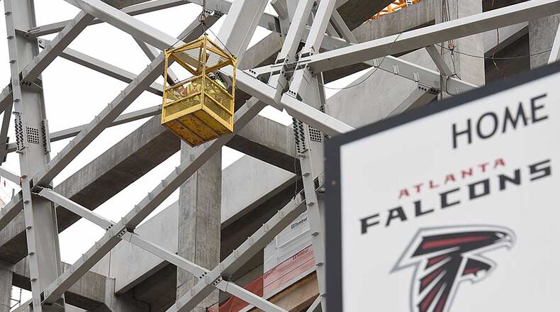 Construction workers continue work at The Mercedes-Benz Stadium, new home of the Atlanta Falcons, in March.