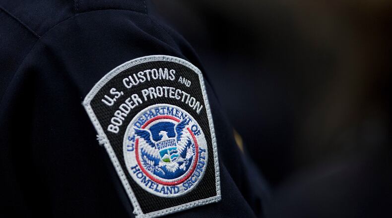 FILE - A customs agent wears a patch for the U.S. Customs and Border Protection agency, Oct. 27, 2017, at John F. Kennedy International Airport in New York. (AP Photo/Mark Lennihan, file)