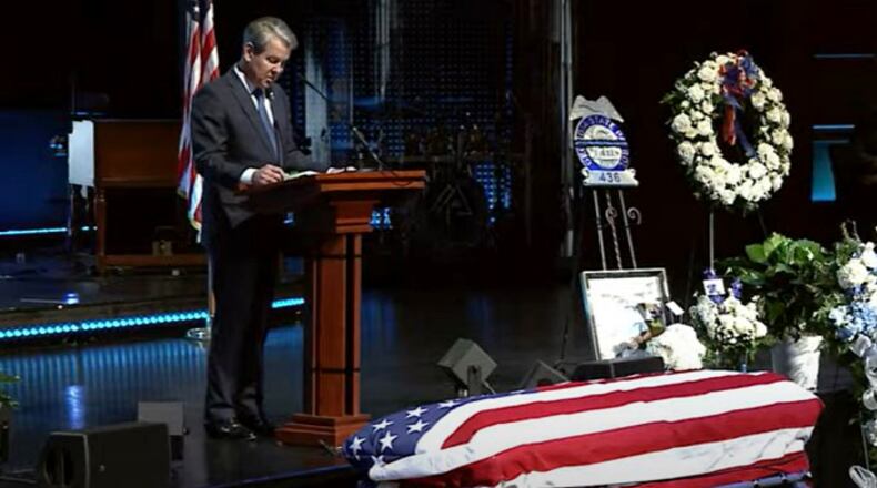 Georgia Gov. Brian Kemp speaks during the Friday funeral for Trooper Jimmy Cenescar.