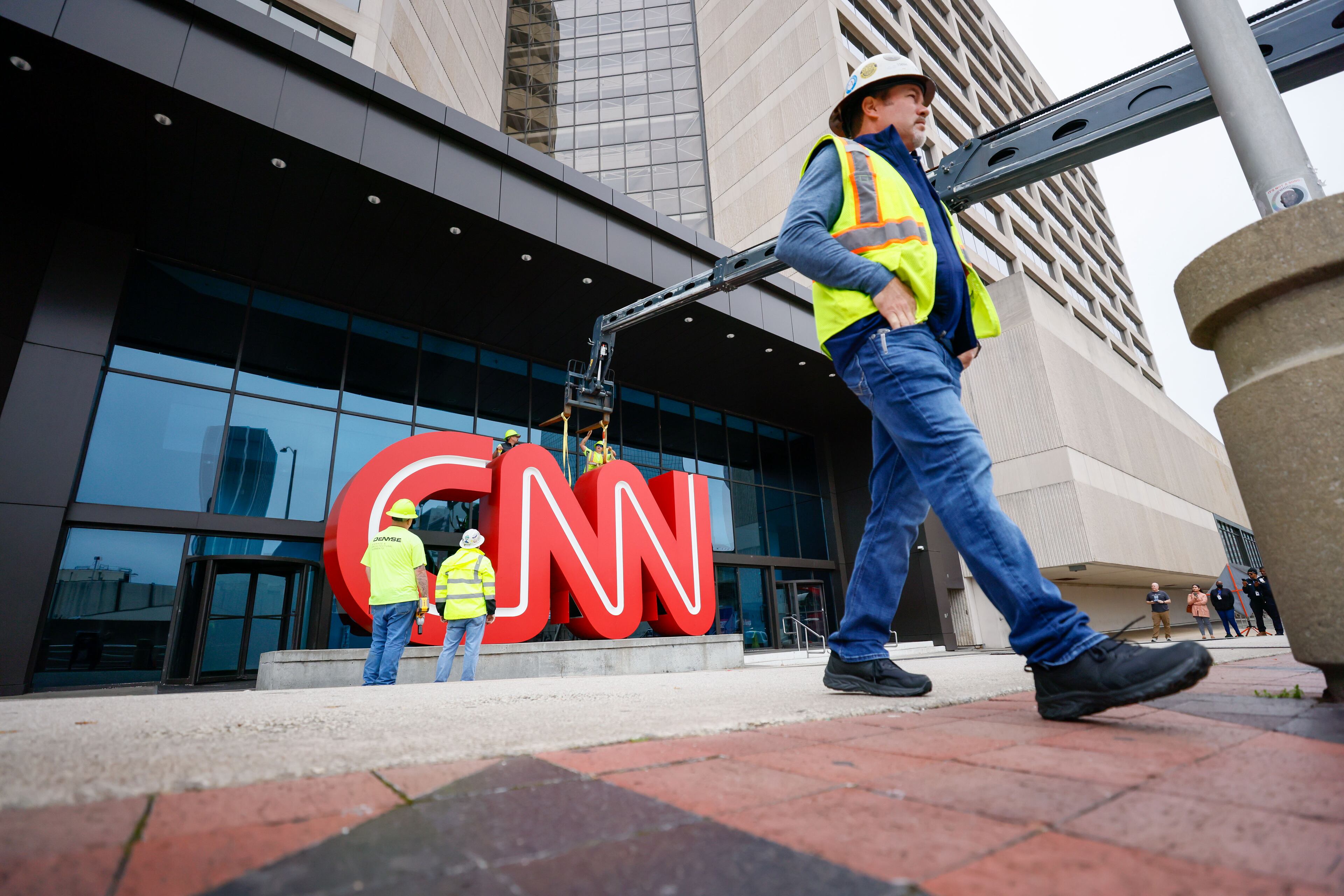 Crew workers were seen removing the iconic CNN sign from the CNN Center downtown on Monday, March 2024. CNN moved its Atlanta operations to the 30-acre Turner Techwood campus in Midtown. (Miguel Martinez/AJC)