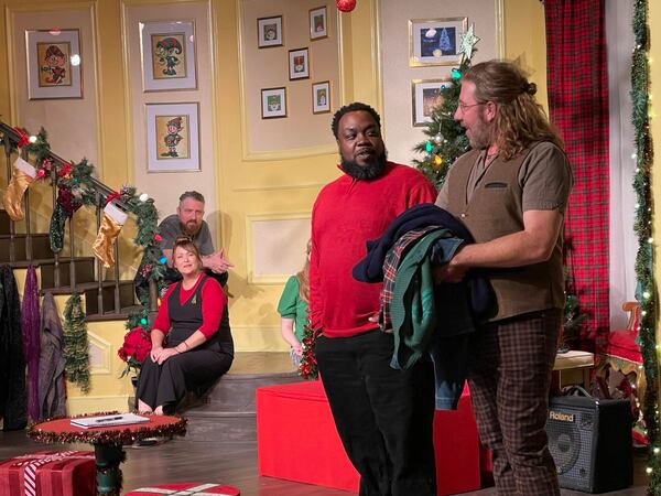 Narrator Topher Payne greets special guest Enoch King during a 2022 improv comedy performance of "Y’allmark Christmas," as improvisers Amber Nash and Kevin Gillese watch from the steps.