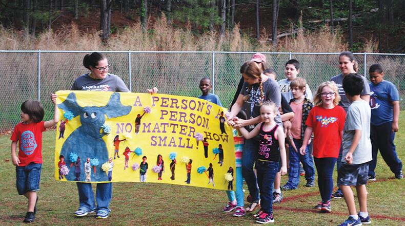 Teacher Jennifer Nettuno and her class at Boston Elementary School, Woodstock, rally behind a banner during the recent Relay for Life, a walkathon fundraiser for the American Cancer Society. The entrance to their school is to be renovated in the Cherokee County schools’ 2018 budget plan. CHEROKEE COUNTY SCHOOLS