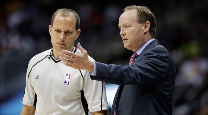 In this Nov. 2, 2016, file photo, Atlanta Hawks head coach Mike Budenholzer, right, talks with referee John Goble in the third quarter of an NBA basketball game against the Los Angeles Lakers in Atlanta. John and Jacyn Goble are the first siblings to be on the NBA's officiating staff at the same time. John is in his 10th season in the league. He encouraged Jacyn to get back into officiating while he worked with the Miami-Dade Police Department, and this season his younger brother was promoted to the NBA's 64-member staff. (AP Photo/David Goldman, File)