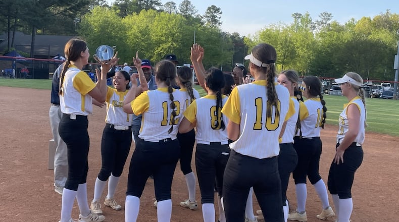 Richmond Hill players celebrate with the trophy after defeating West Laurens 8-6 in the GHSA slow-pitch softball championship game on April 17, 2025, at the Twin Creeks Softball Complex in Woodstock.