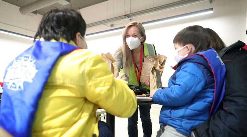 Vaccine ambassador Marisol Alfaro hands out gift bags to children getting vaccinated at Richard J. Daley College in the Ford City neighborhood Saturday, Jan. 22, 2022, in Chicago. Alfaro has also worked as a contact tracer. (John J. Kim/Chicago Tribune/TNS)