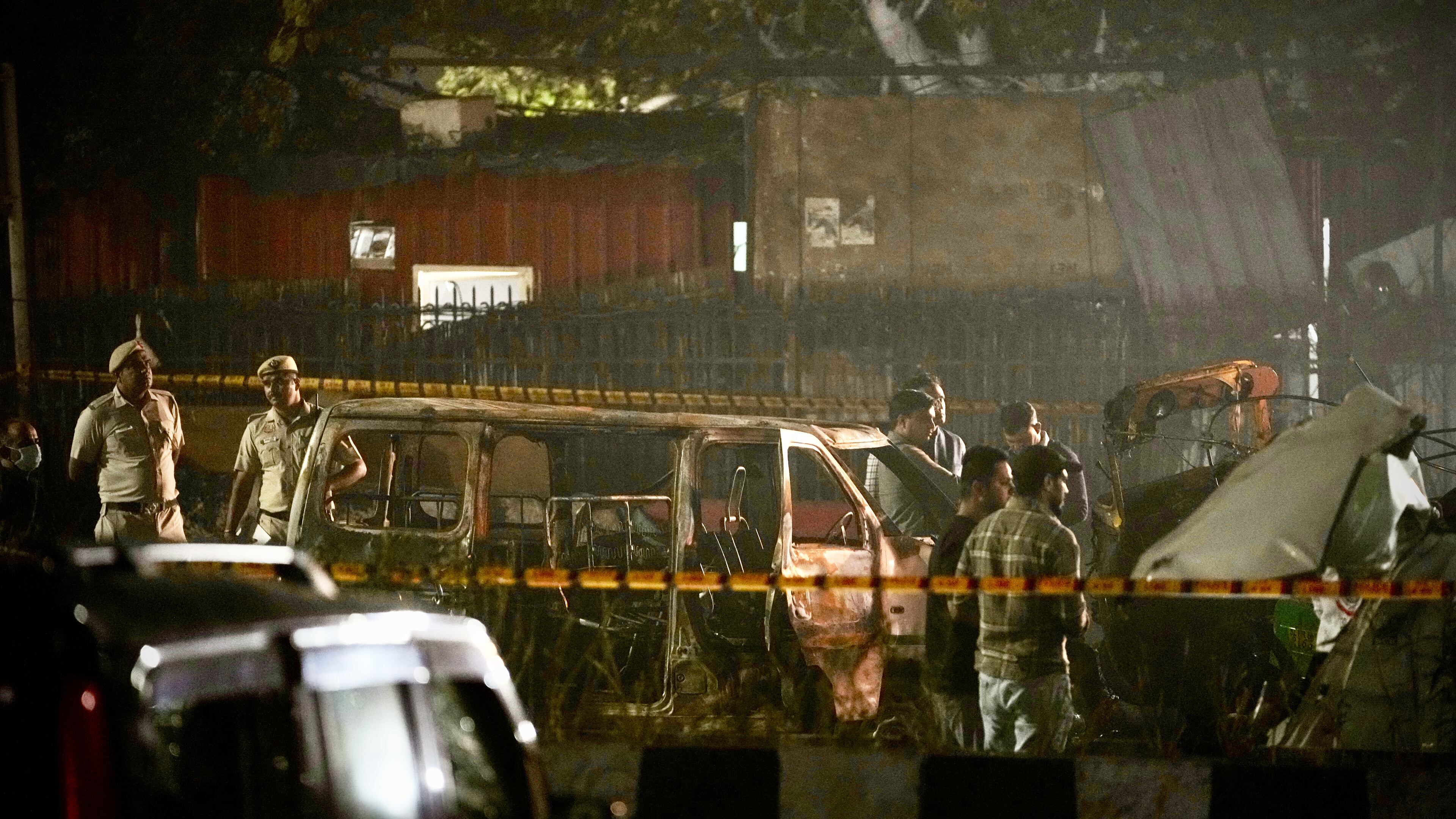 Security officials inspect damaged vehicles at the site after a car explosion near the historic Red Fort in New Delhi, India, Monday, Nov. 10, 2025. (AP Photo/Manish Swarup)
