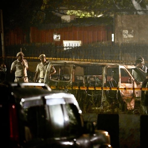 Security officials inspect damaged vehicles at the site after a car explosion near the historic Red Fort in New Delhi, India, Monday, Nov. 10, 2025. (AP Photo/Manish Swarup)