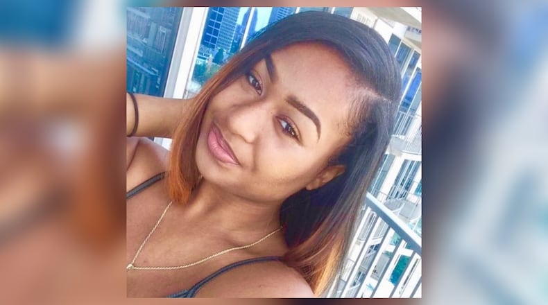 Abree Boykin, a Black woman who was murdered, poses on a balcony.