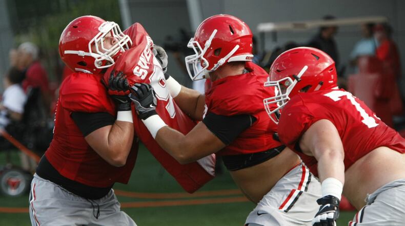 John Theus (center) and Kolton Houston (right) have combined for 54 career starts. (AJC/Josh Jones)