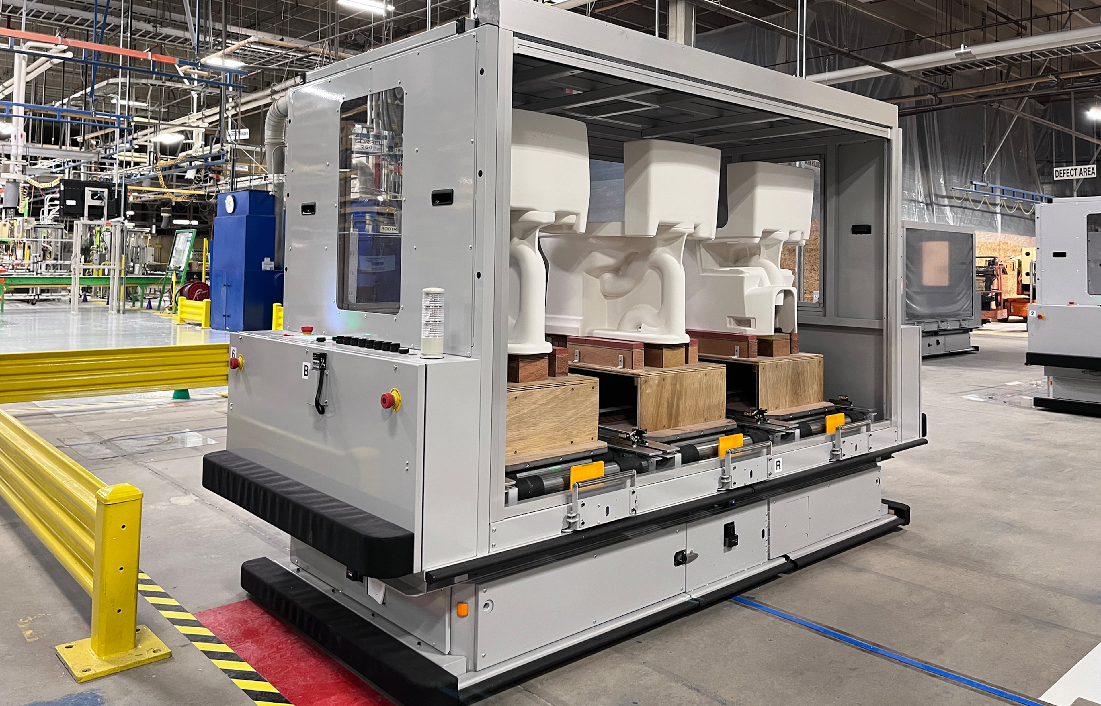 An Automated Guided Vehicle, or AGV, transports three toilets at a time between molding, drying, glazing and firing stations at Toto's factory in Morrow. (Courtesy of Toto USA)