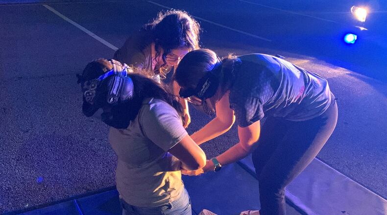 Participants in Suwanee's 2019 Citizen's Police Academy engaging in a traffic stop simulation.