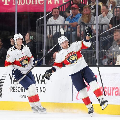 Florida Panthers center Eetu Luostarinen (27) and left wing Brad Marchand (63) celebrate after Marchand's goal against the Vegas Golden Knights during the second period of an NHL hockey game Monday, Nov. 10, 2025, in Las Vegas. (AP Photo/Ian Maule)