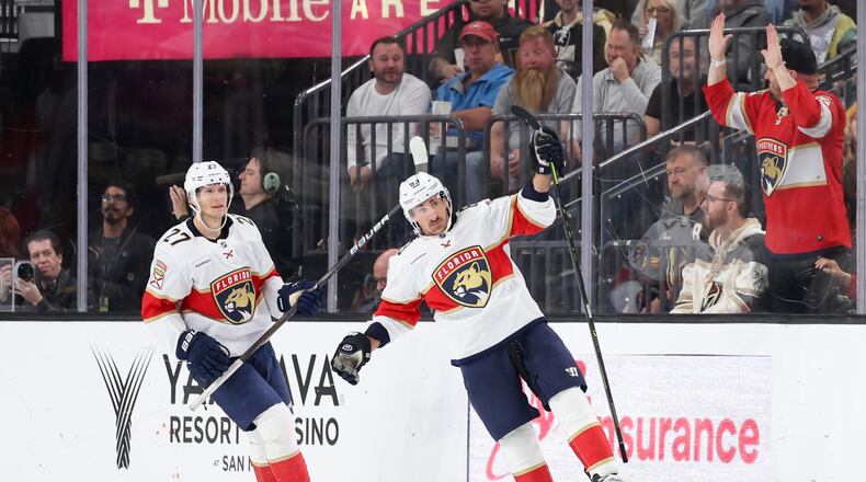 Florida Panthers center Eetu Luostarinen (27) and left wing Brad Marchand (63) celebrate after Marchand's goal against the Vegas Golden Knights during the second period of an NHL hockey game Monday, Nov. 10, 2025, in Las Vegas. (AP Photo/Ian Maule)