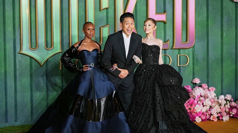 Cynthia Erivo, from left, director Jon M. Chu and Ariana Grande pose for photographers upon arrival at the premiere of the film "Wicked For Good" in London, Monday, Nov. 10, 2025. (Photo by Scott A Garfitt/Invision/AP)
