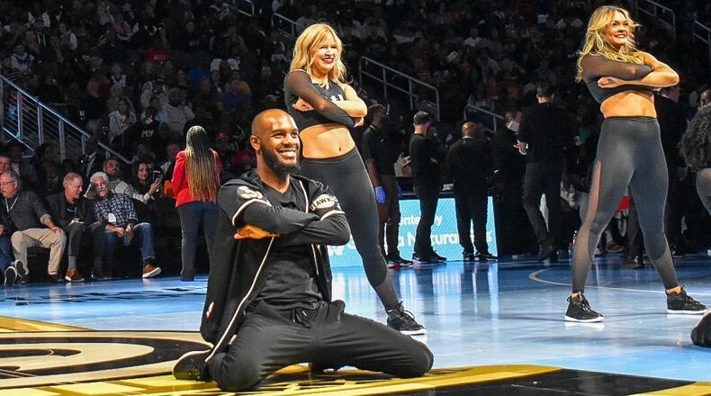 Calvin Brown (center) and fellow ATL Dancers perform at an Atlanta Hawks game. He's been with the dance team since 2021, and is preparing to pursue other career goals. (Courtesy of Atlanta Hawks)