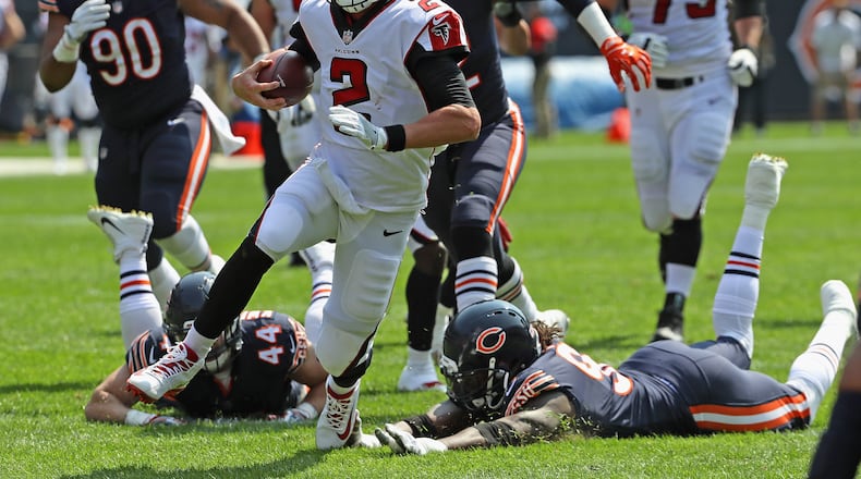 Matt Ryan of the Falcons runs for a first down against the Bears during the season-opening game Sunday at Chicago's Soldier Field.