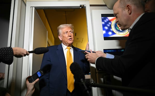 FILE - President Donald Trump speaks to the reporters on board Air Force One on the way to Miami on April 12, 2025. (Pool via AP, File)