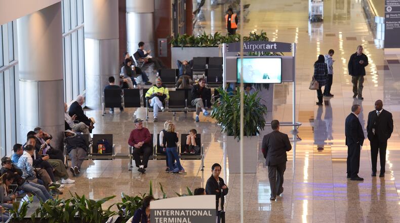Travelers' families and friends wait at arriving area of Maynard H. Jackson Jr. International Terminal on Tuesday, March 22, 2016. Bombs exploded at the Brussels airport and one of the city's metro stations Tuesday, killing at least 31 people and wounding dozens, as a European capital was again locked down amid heightened security threats. HYOSUB SHIN / HSHIN@AJC.COM