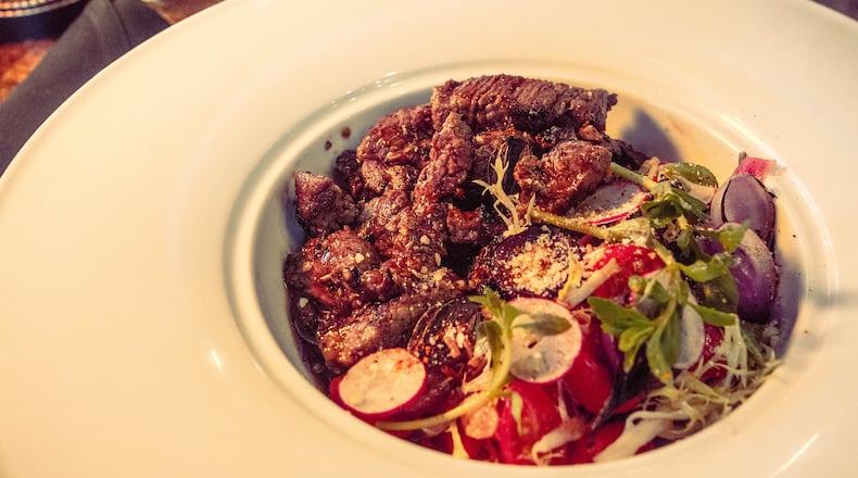 Shaking Beef 8-ounce filet mignon with frisée salad and marinated tomatoes from the menu of Girl Diver. Shaking beef will also appear on the menu at Bar Diver.
Courtesy of Girl Diver