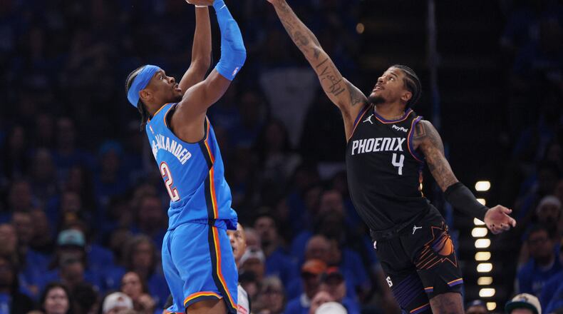 Oklahoma City Thunder guard Shai Gilgeous-Alexander (2) looks to shoot over Phoenix Suns guard Jalen Green (4) during the first half in Game 1 of a first-round NBA playoffs basketball series Sunday, April 19, 2026, in Oklahoma City. (AP Photo/Nate Billings)
