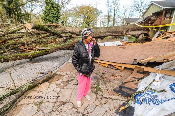 Rosie Gray's home was damaged when a storm sent a tree crashing into her house and two others. JOHN SPINK / JSPINK@AJC.COM