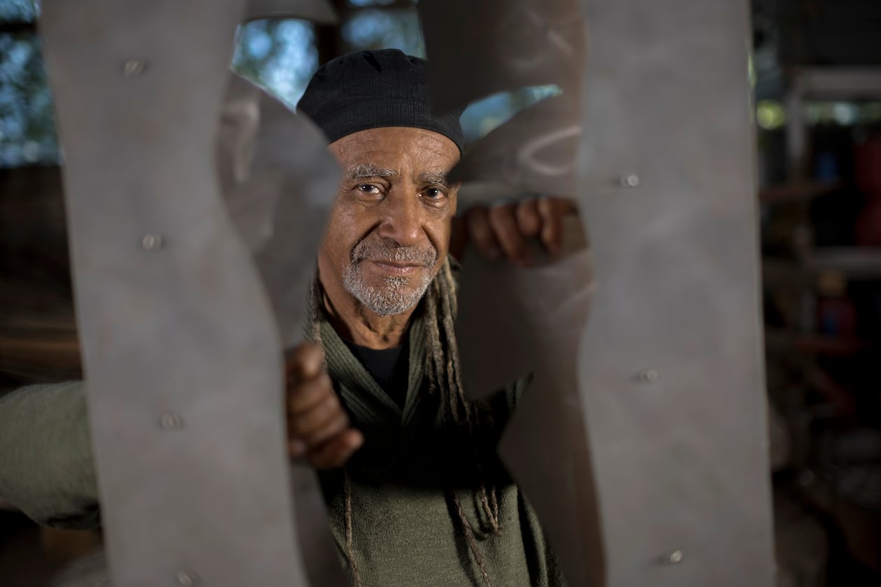 Jerome Meadows, renowned for his public arts projects, stands behind his aluminum and limestone sculpture titled, "Spirit In Nature" at his studio in Savannah, Ga. on Wednesday, Feb. 7, 2024. (AJC Photo/Stephen B. Morton)