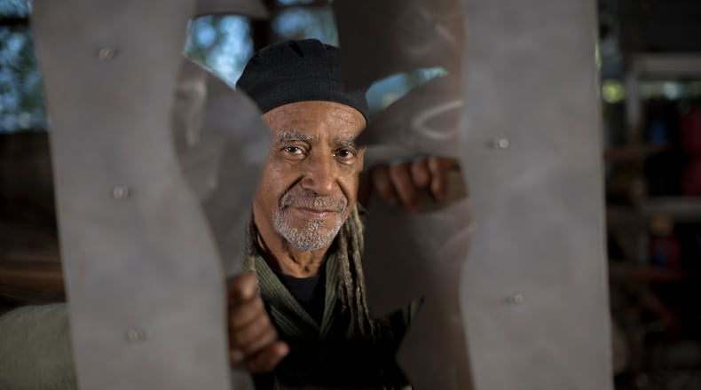 Jerome Meadows, renowned for his public arts projects, stands behind his aluminum and limestone sculpture titled, "Spirit In Nature" at his studio in Savannah, Ga. on Wednesday, Feb. 7, 2024. (AJC Photo/Stephen B. Morton)