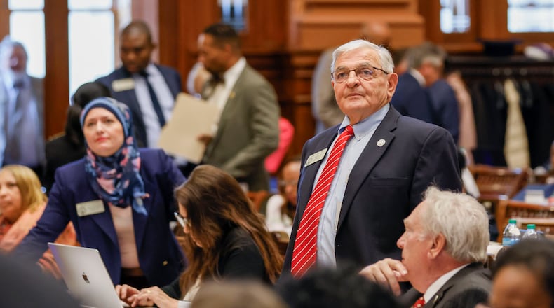 State Reps. Ruwa Romman (left), D-Duluth, and Danny Mathis (right) R-Cochran, watch for results as the House votes on a bill at the Capitol in Atlanta on Wednesday. (Miguel Martinez/ AJC)