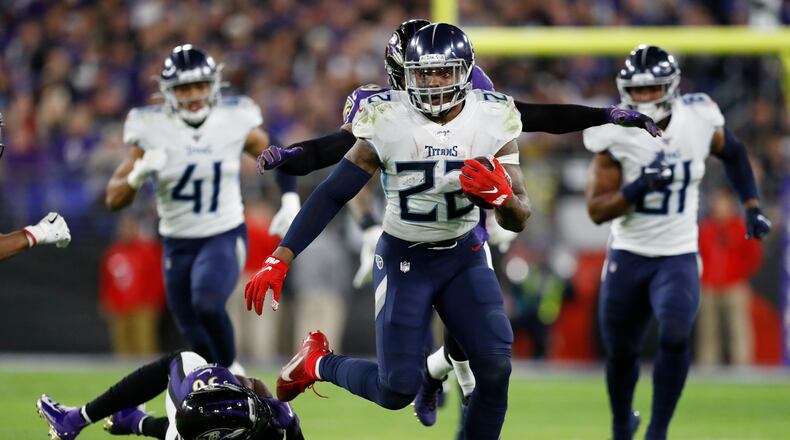 Tennessee Titans running back Derrick Henry (22) runs past Baltimore Ravens strong safety Chuck Clark (36) during the second half of an NFL divisional playoff football game, Saturday, Jan. 11, 2020, in Baltimore. (AP Photo/Julio Cortez)