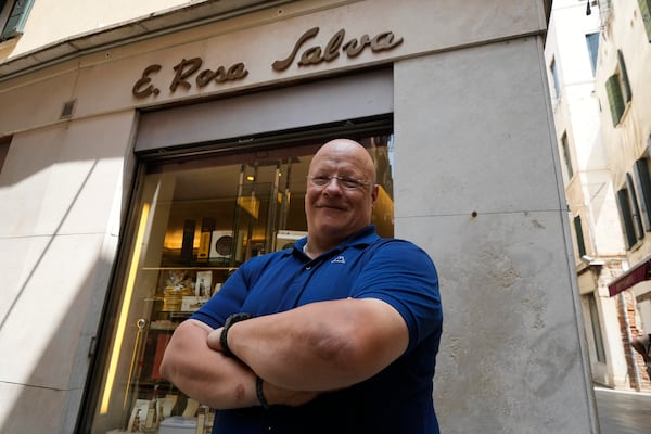 Andrea Rosa Salva pastry shop owner poses outside his shop in Venice, Italy, Thursday, June 12, 2025. (AP Photo/Luca Bruno)