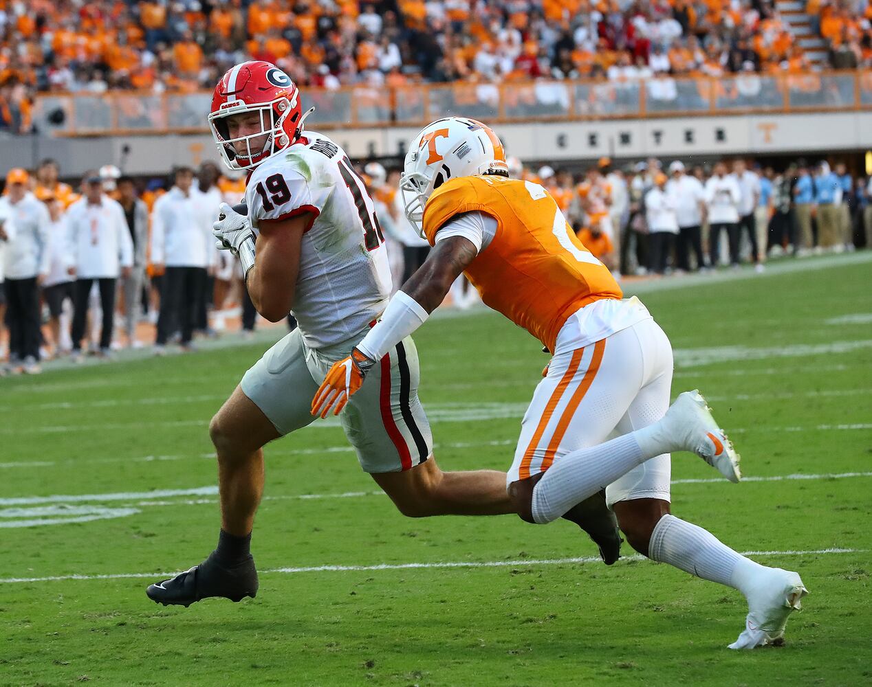 Georgia tight end Brock Bowers gets into the endzone past Tennessee defensive back Jaylen McCollough to take a 24-7 lead during the second quarter in a NCAA college football game on Saturday, Nov. 18, 2023, in Knoxville.  Curtis Compton for the Atlanta Journal Constitution