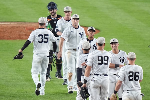 New York Yankees' Cody Bellinger (35), Aaron Judge (99) and DJ LeMahieu (26) celebrate with teammates after a baseball game against the New York Mets Sunday, May 18, 2025, in New York. (AP Photo/Frank Franklin II)