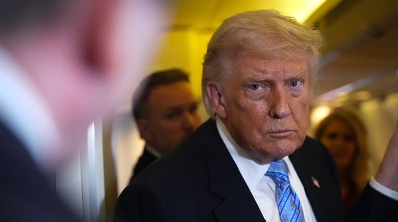 President Donald Trump speaks to reporters aboard Air Force One, Friday, May 15, 2026, as he returns from a trip to Beijing, China. (AP Photo/Mark Schiefelbein)