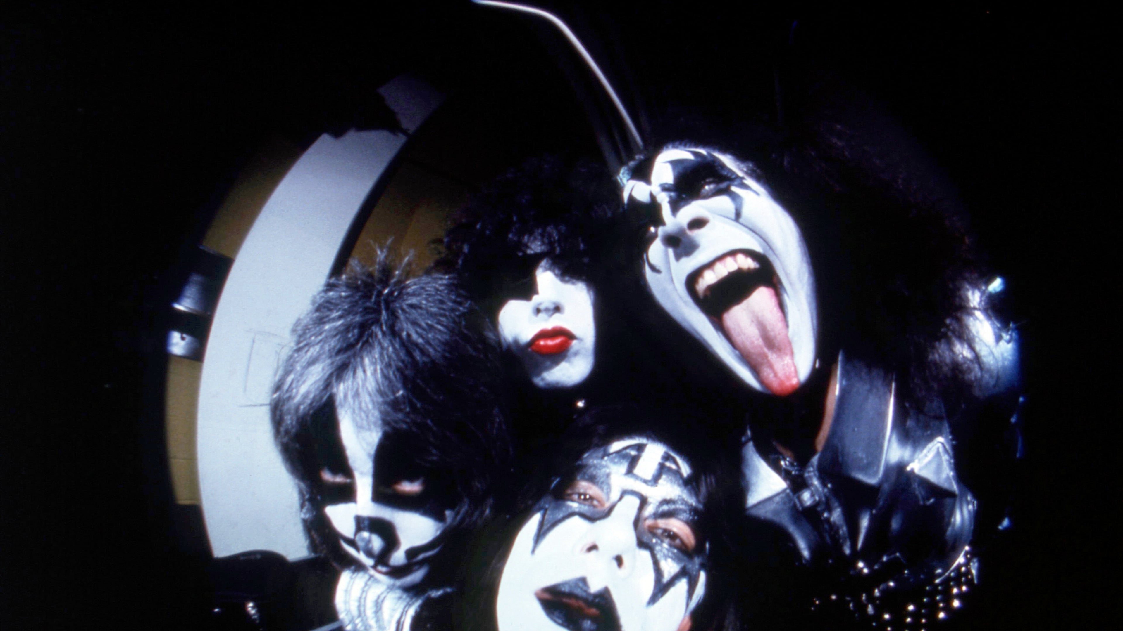 FILE - In this image taken with a fisheye lens, members of the rock group Kiss, clockwise from right, Gene Simmons,, Ace Frehley, Peter Criss and Paul Stanley pose before a concert in Hartford, Conn., Feb. 16, 1977. (AP Photo/Richard Drew, File)