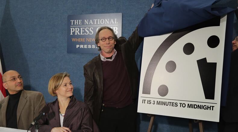 Arizona State University New Origins Initiative Director Lawrence Krauss (C) and Bulletin of the Atomic Scientists Science and Security Board member Thomas Pickering (R) unveil the latest version of the Doomsday Clock with Stockholm Environment Institute Senior Scientist Sivan Kartha (L) and Center for Strategic and International Studies' Proliferation Prevention Program Director Sharon Squassoni during a news conference at the National Press Club January 26, 2016 in Washington, DC. The bulletin's Science and Security Board takes into consideration 'the number and kinds of nuclear weapons in the world, the parts per million of carbon dioxide in the atmosphere, the degree of acidity in our oceans and the rate of sea level rise' when setting the clock as a warning against self-destruction.