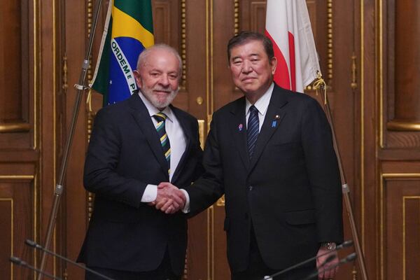 Brazil's President Luiz Inacio Lula da Silva, left, shakes hands with Japan's Prime Minister Shigeru Ishiba during their meeting at the Akasaka Palace State Guest House in Tokyo Wednesday, March 26, 2025. (Kazuhiro Nogi/Pool Photo via AP)