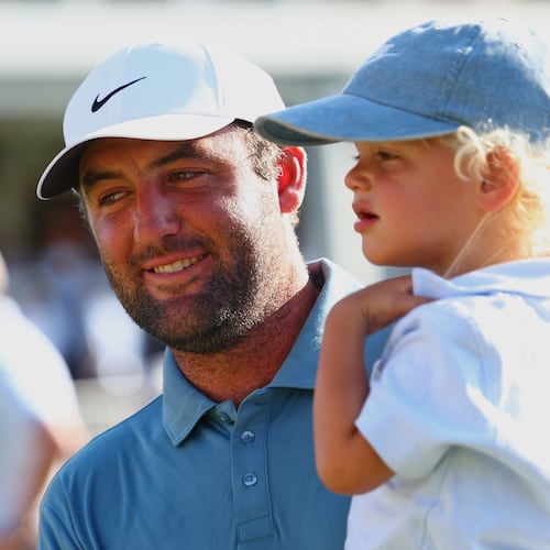 Scottie Scheffler holds his child Bennett after winning the PGA Tour Championship golf tournament Sunday, Aug. 30, 2026, in Atlanta. (AP Photo/Colin Hubbard)