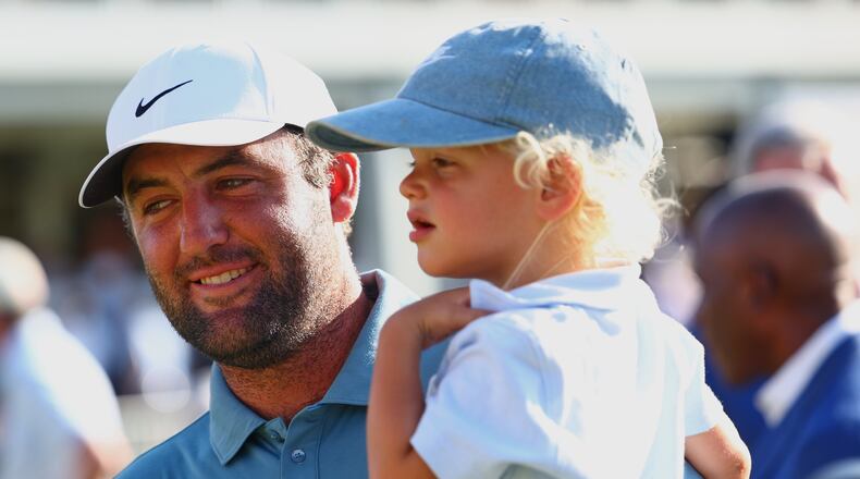 Scottie Scheffler holds his child Bennett after winning the PGA Tour Championship golf tournament Sunday, Aug. 30, 2026, in Atlanta. (AP Photo/Colin Hubbard)