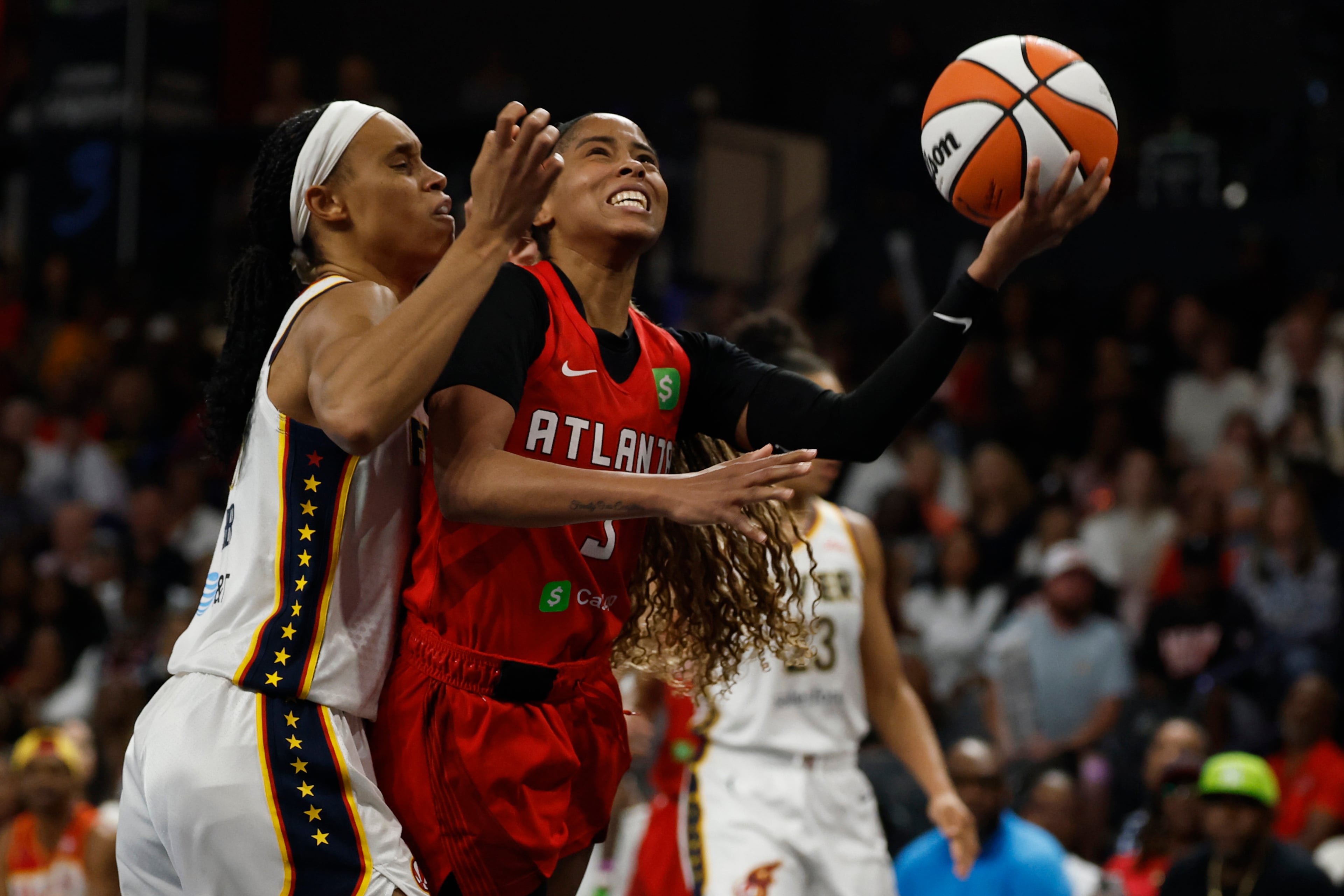 Atlanta Dream guard Jordin Canada, front right, is fouled by Indiana Fever forward Brianna Turner, left, as she shoots during the second half of Game 3 in the first round of the WNBA basketball playoffs, Thursday, Sept. 18, 2025, in Atlanta. (AP Photo/Butch Dill)