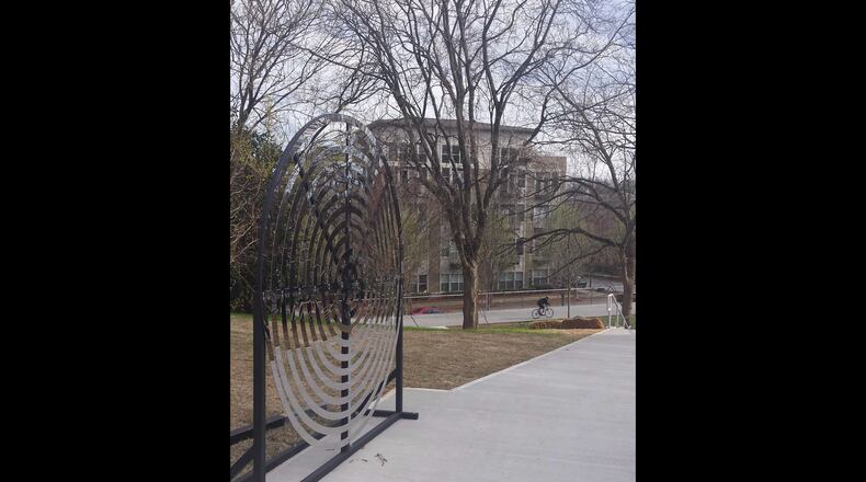Perennial Properties constructed a 200-foot path and stairway to the Beltline. It features bike runnels and a mirrored sculpture by Dana Haugaard.