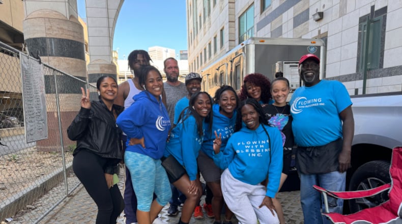 Flowing with Blessings is a non-profit created by Nicky Crawford (far right) that provides showers and launders clothes for the unhoused community in Atlanta. Courtesy of Christina Moss