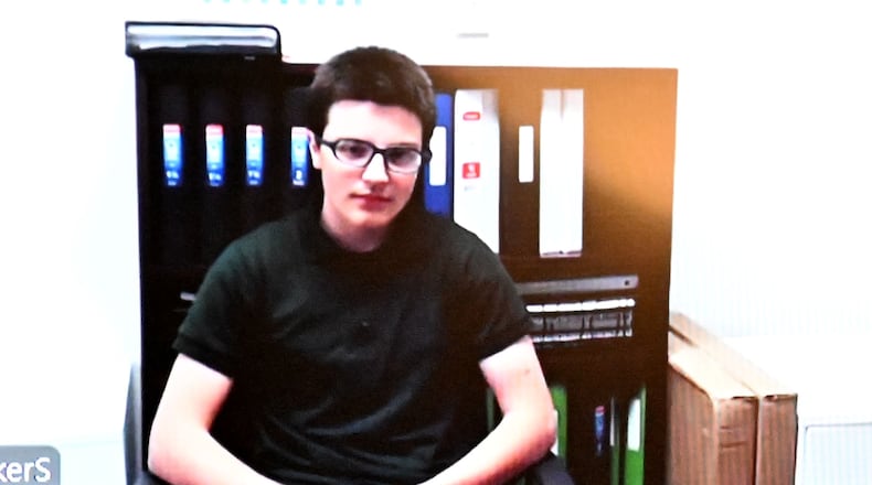 Colt Gray (left) appears on screen via a video link as Barrow County Superior Court Judge Nicholas Primm presides during a virtual hearing of Colt Gray at Barrow County Courthouse, Tuesday, May 6, 2025, in Winder. Colt Gray, the alleged Apalachee shooter, is expected appear in court for the first time in months after filing a motion asking for his trial to move out of Barrow County. Colt Gray, 14, was indicted on 55 charges in the Sept. 4 shooting including four counts of murder. His attorneys filed a motion seeking a change of venue citing that it was necessary “to ensure Gray receives a fair trail before an impartial jury.” (Hyosub Shin / AJC)