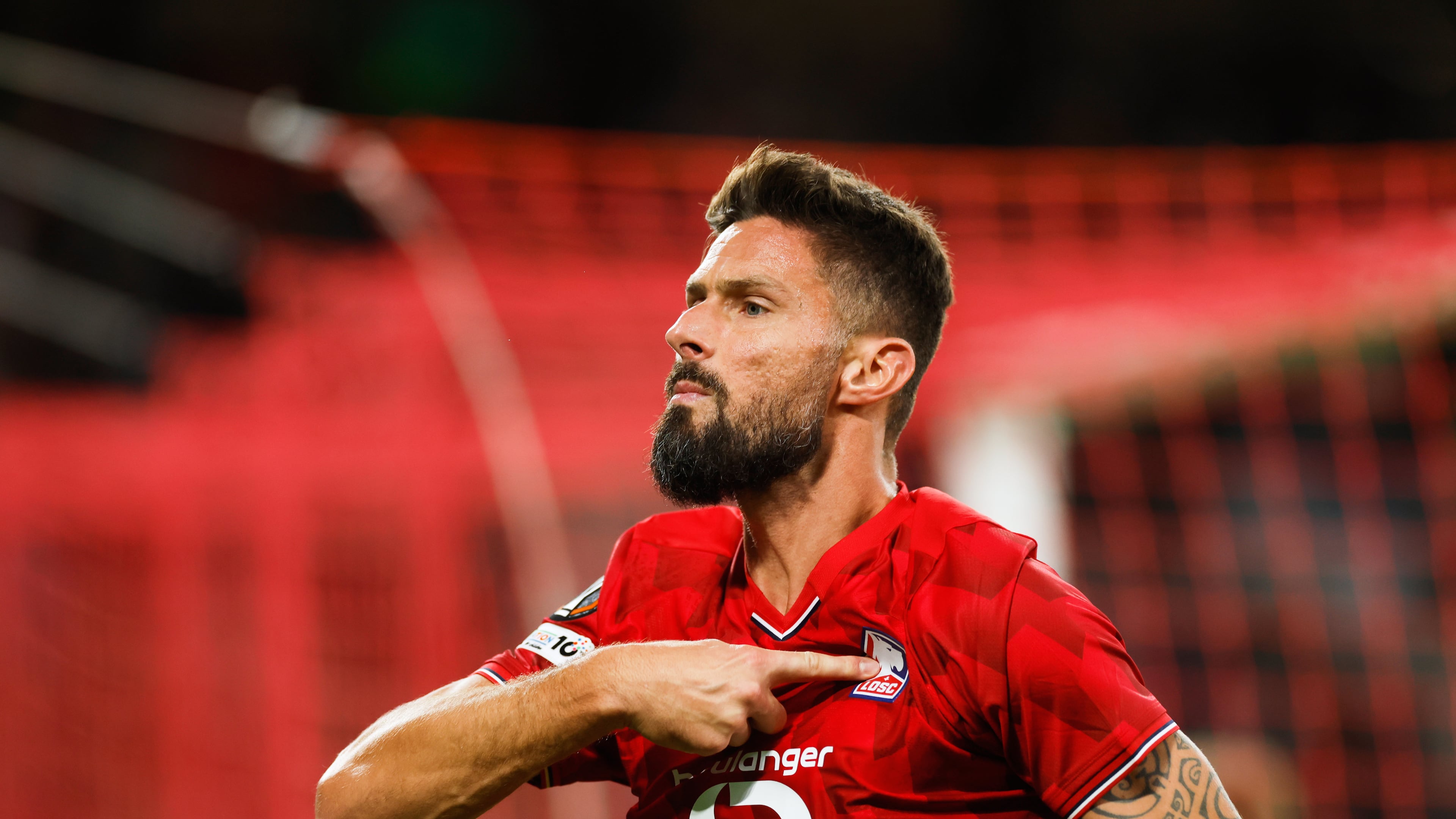 Lille's Olivier Giroud celebrates after scoring his sides second goal during the Europa League soccer match between Lille and Brann at the Pierre Mauroy stadium in Villeneuve d'Ascq, northern France, Thursday, Sept. 25, 2025. (AP Photo/Jean-Francois Badias)