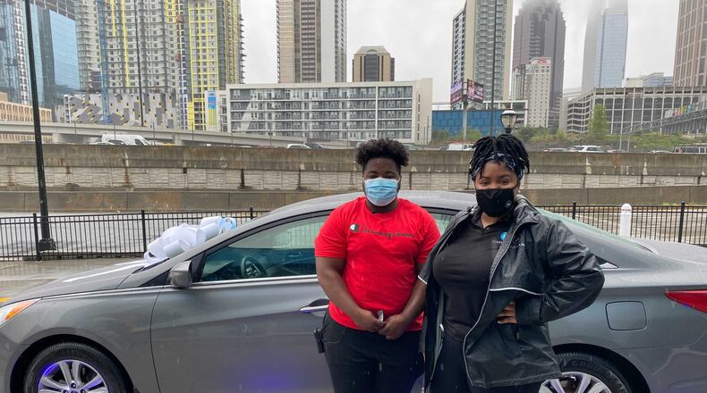 Carvana's BEACON community donated $20,000 to Georgia Building Trades Academy's YouthBuild program, 4Wheels 4Work initiative. The money will provide two students with "vehicle" scholarships. First recipient, Sean Lattimore (L) is shown in front of his new vehicle next to Raechelle Mack, Carvana customer advocate.