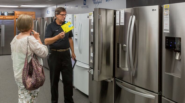 Gail Peterson, Boynton Beach, looks at refrigerators Wednesday with sales counselor Walter Fron at Rosner’s Appliance in West Palm Beach. “My fridge is dying,” Peterson said. Fron explained the upcoming Florida state sales tax rebate on Energy Star appliances during her visit to the store.