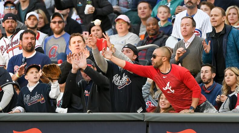 Braves fans reach for a foul ball.