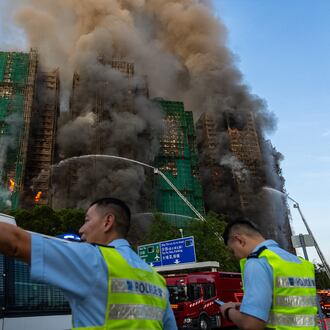 First responders work the scene of a fire at Wang Fuk Court, a residential estate in the Tai Po district of Hong Kong's New Territories on Wednesday, Nov. 26 2025. (AP Photo/Chan Long Hei)