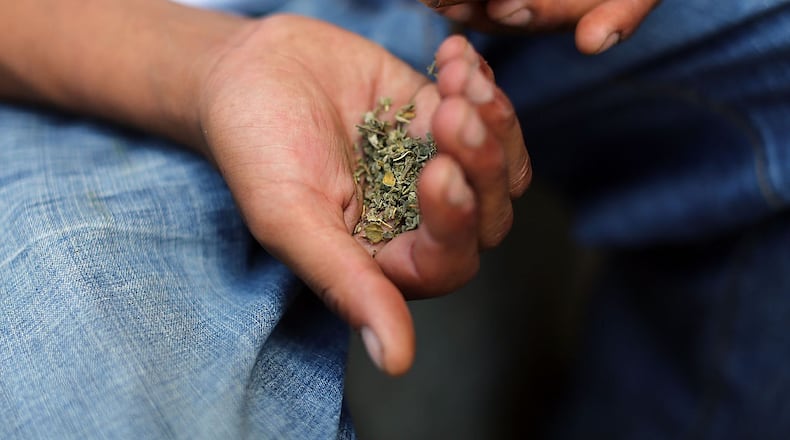 A man prepares to smoke K2 or "Spice", a synthetic marijuana drug. Cities around the country are experiencing a deadly epidemic of synthetic marijuana usage including varieties known as K2 or "Spice" which can cause extreme reactions in some users.